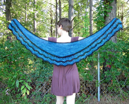 Djoser Shawl knitting pattern by Cassie Castillo.  Crescent Shawl with two color lace border with bobbles.