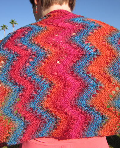 Desert Waves Scarf and Shawl knitting pattern by Cassie Castillo.  Zig zag stitch worked in a self striping yarn.