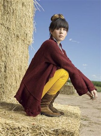 Erte Cardigan by Cassie Castillo.  Cabled sweater worked in one piece from center out.  