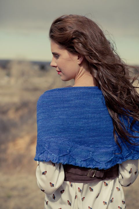 Emmylou Shawl knitting pattern by Cassie Castillo.  Crescent shawl with cable and ruffle border.