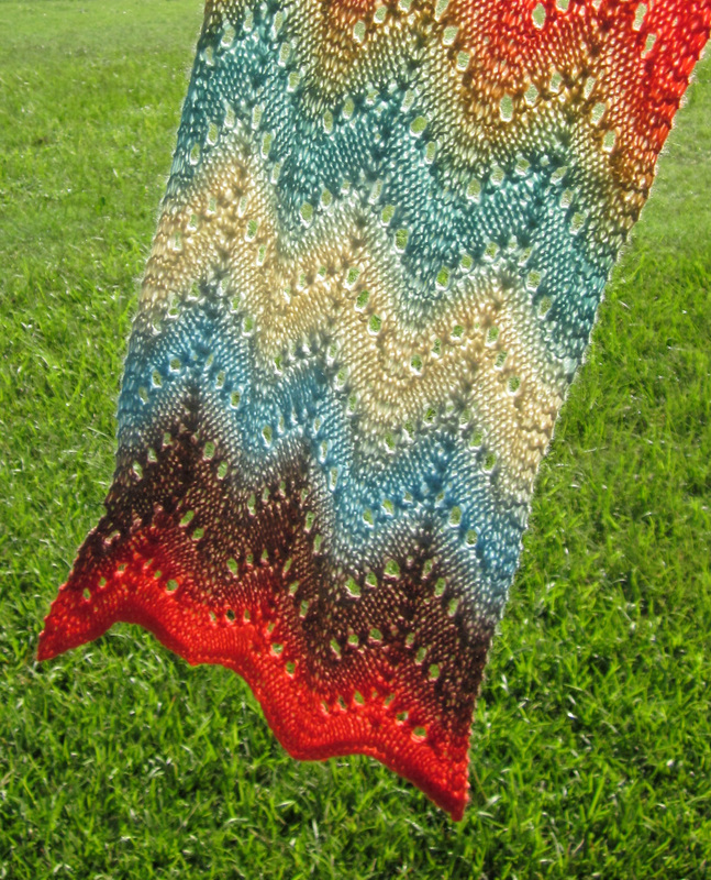 Desert Waves Scarf and Shawl knitting pattern by Cassie Castillo.  Zig zag stitch worked in a self striping yarn.